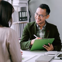 Recruiter and candidate discussing casual job compliance and flexibility in a staffing agency office.