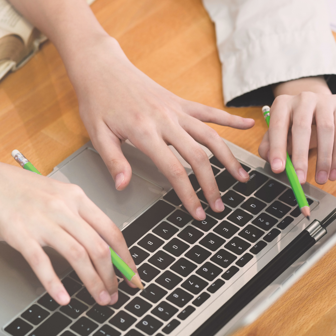 Hands typing on a laptop representing recruiters managing multiple jobs and poly-employment in today’s workforce.
