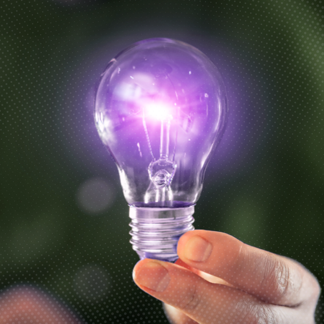 hand holding a purple lightbulb